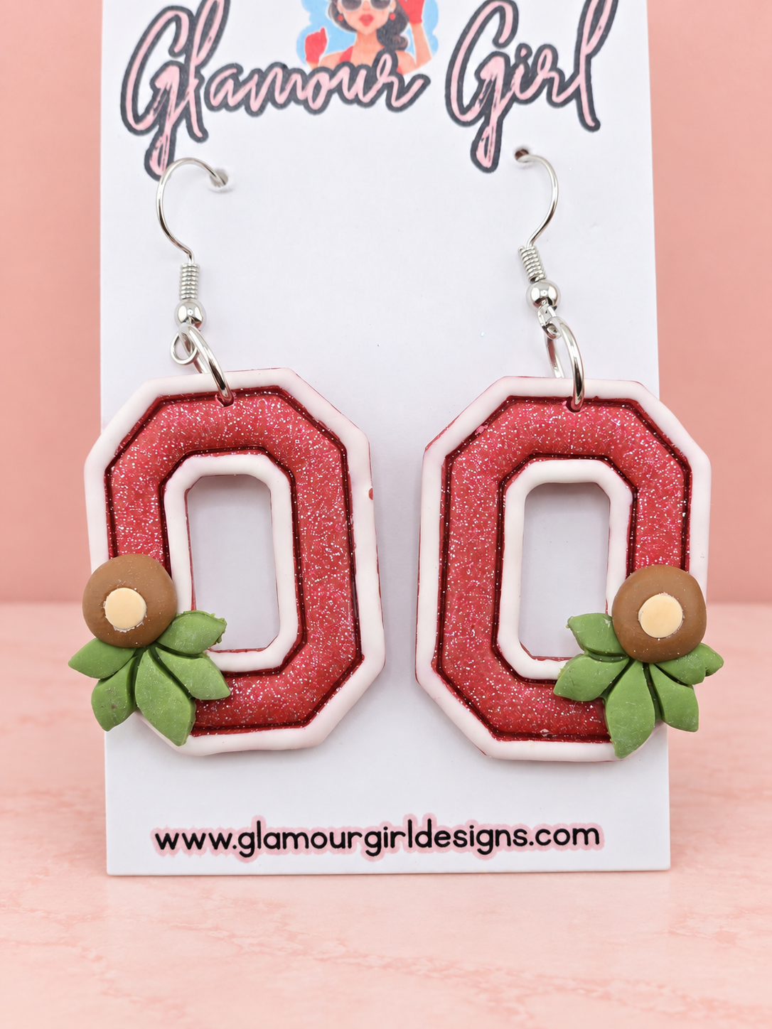 Scarlet Buckeye Block O earrings on blush pink background