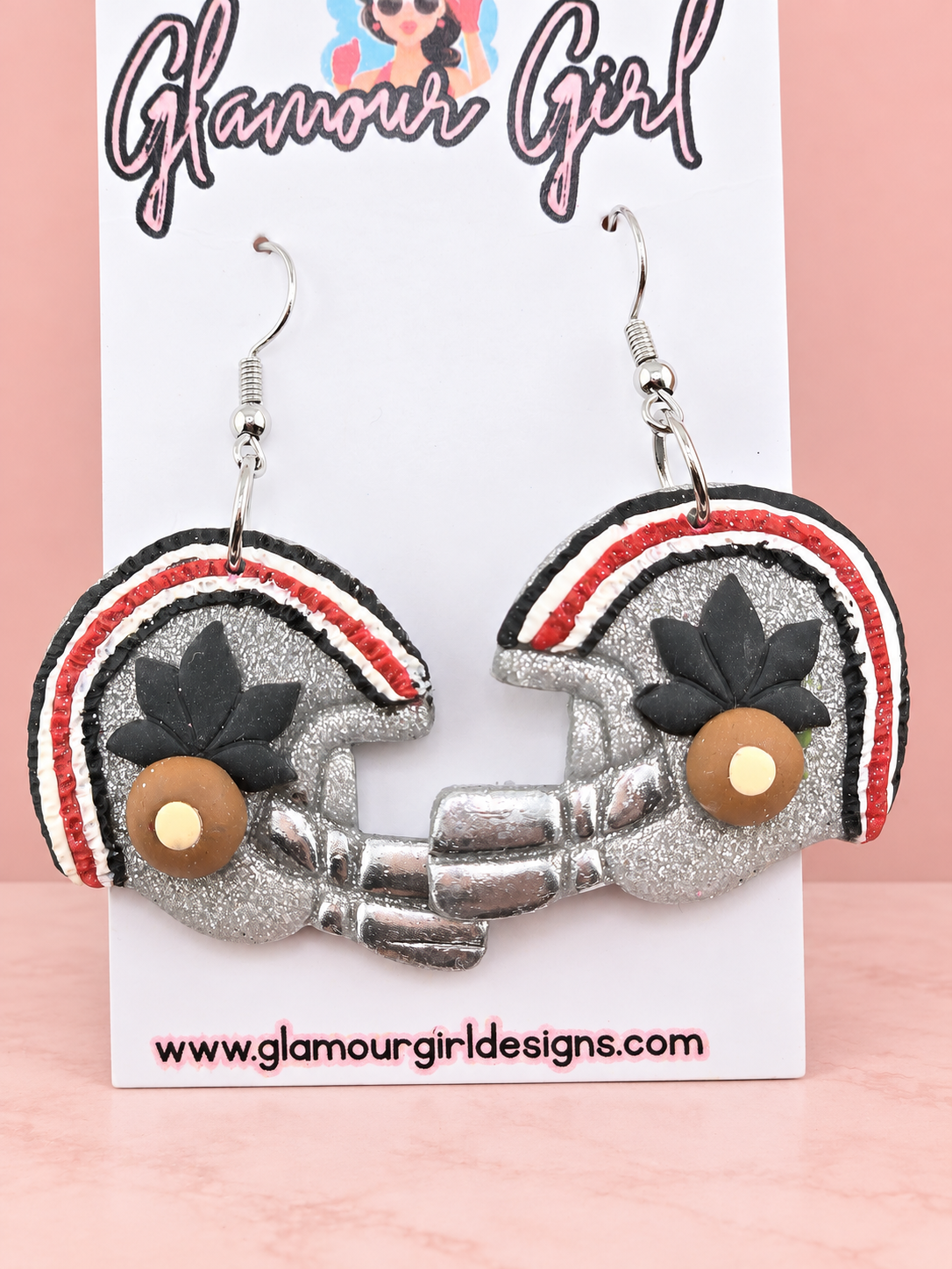 Buckeye helmet earrings alternate view on blush pink background