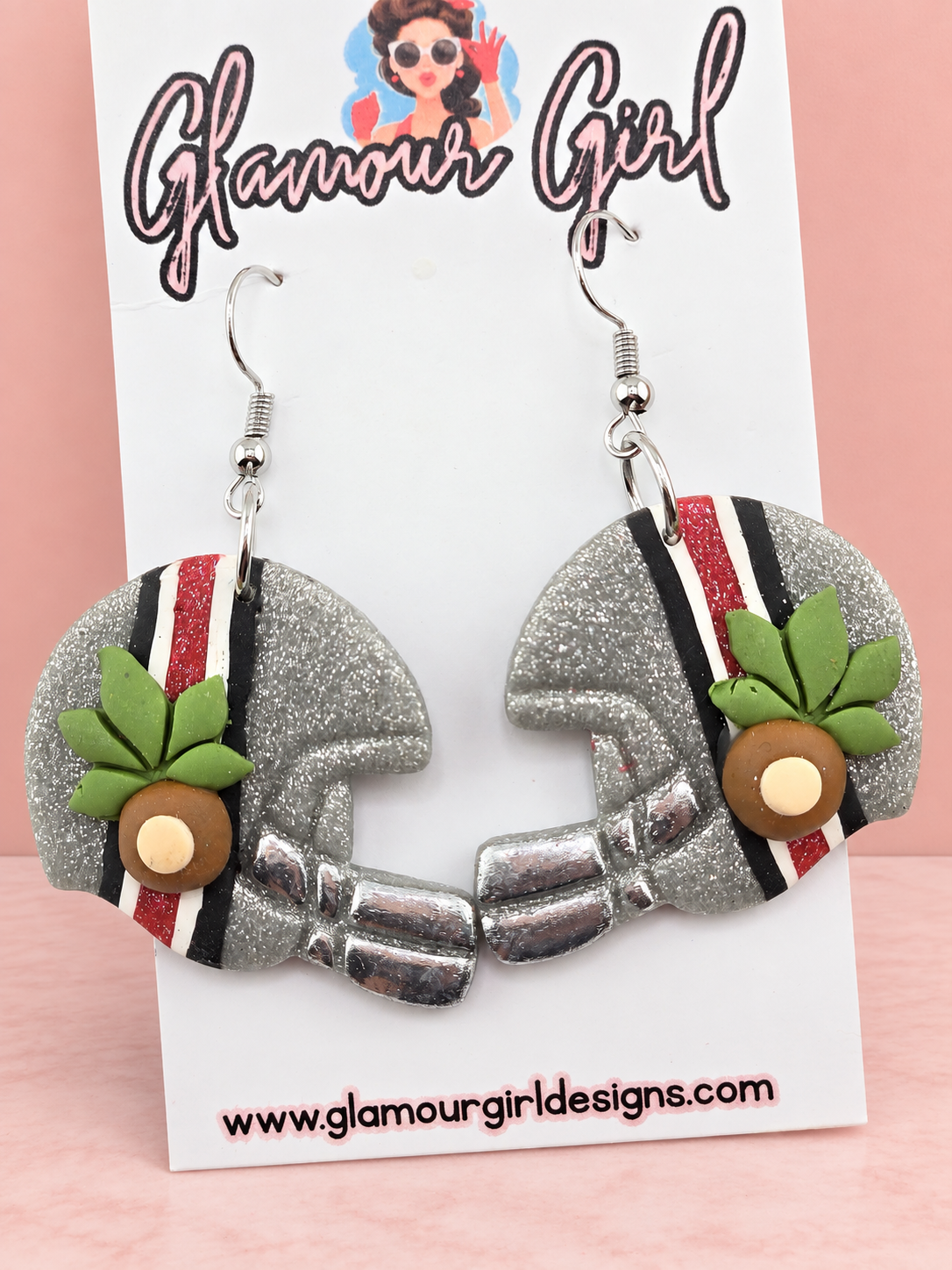 Buckeye helmet earrings close view on blush pink background