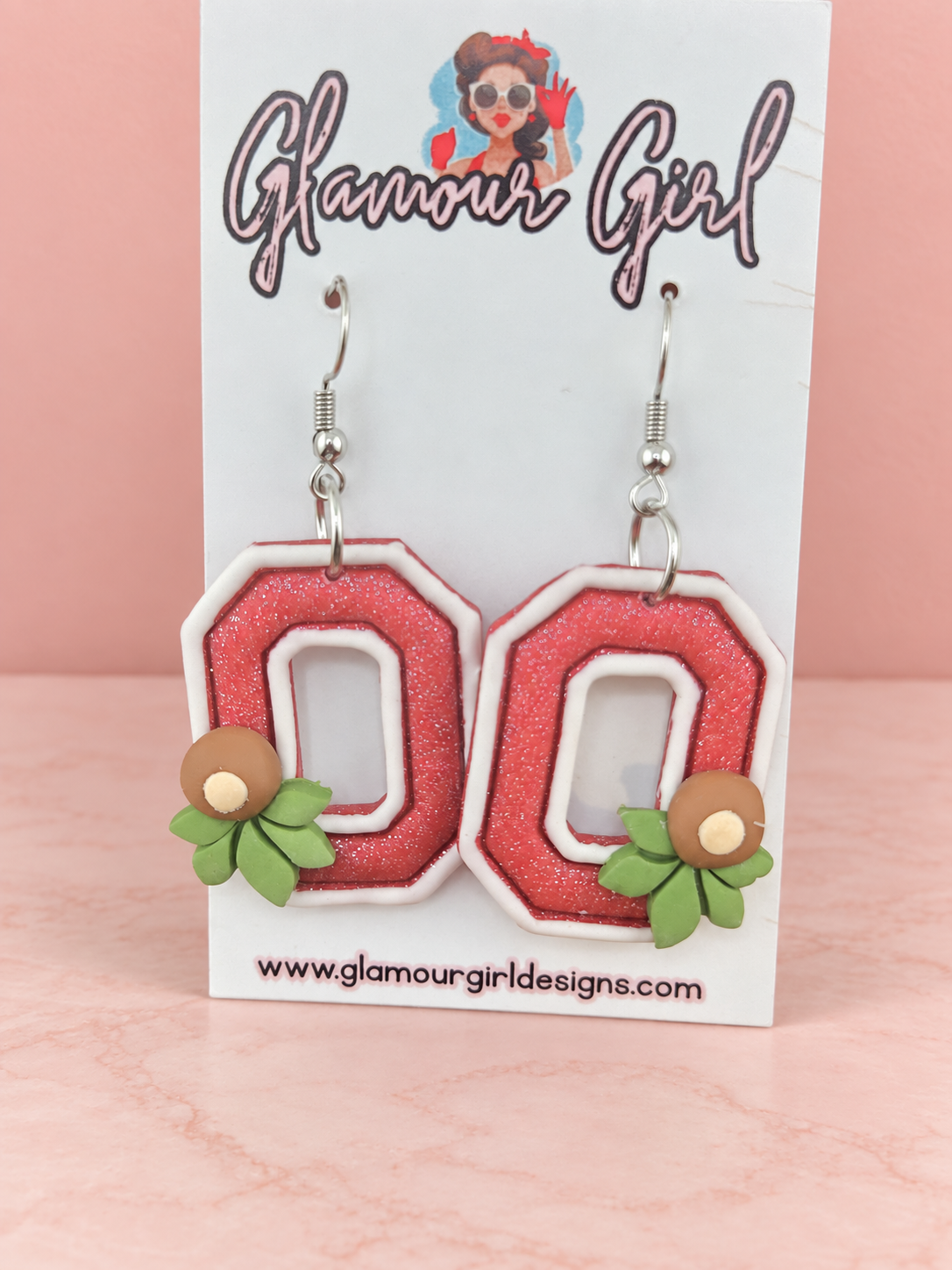 Scarlet Buckeye Block O earrings close view on blush pink background
